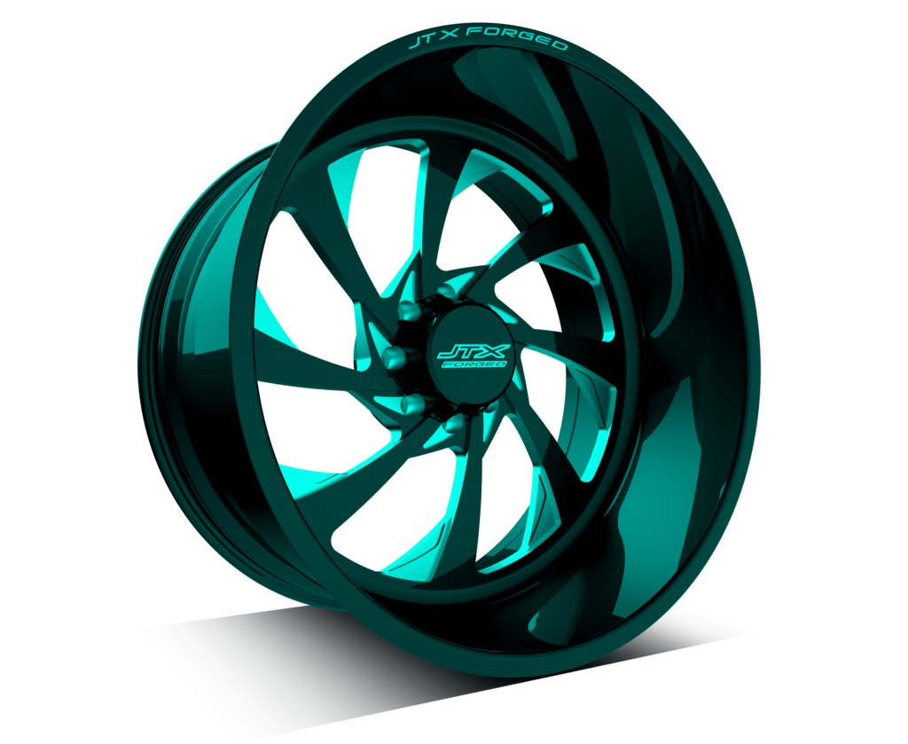 Turquoise alloy wheel on black background.