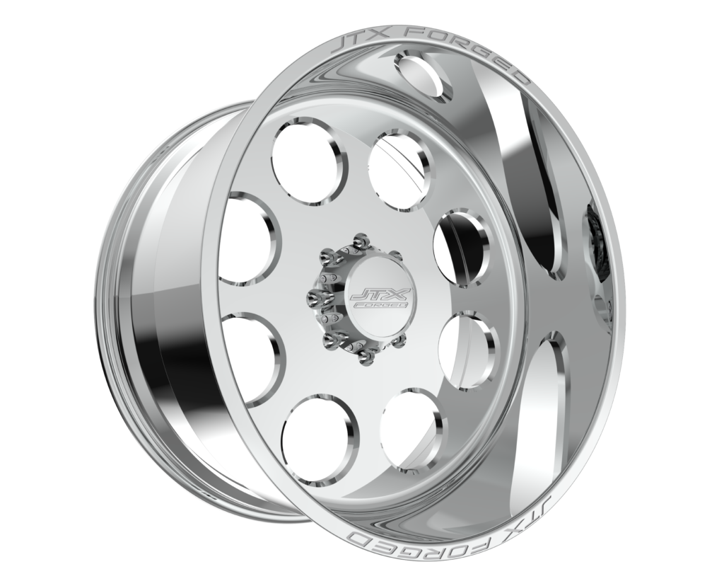A shiny silver car rim with circular holes.