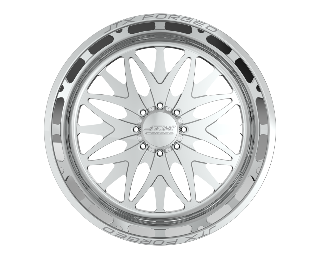 Silver car wheel rim with intricate design.
