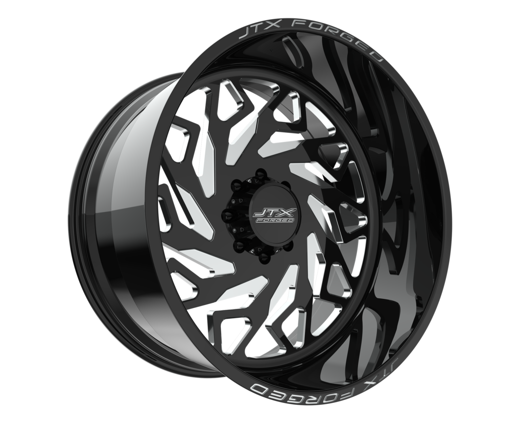 Black and silver wheel with geometric design.