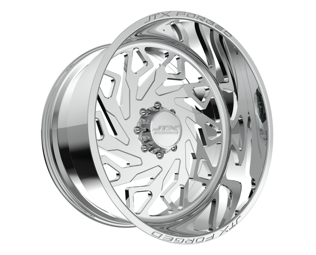 Chrome car wheel with intricate cutout design.