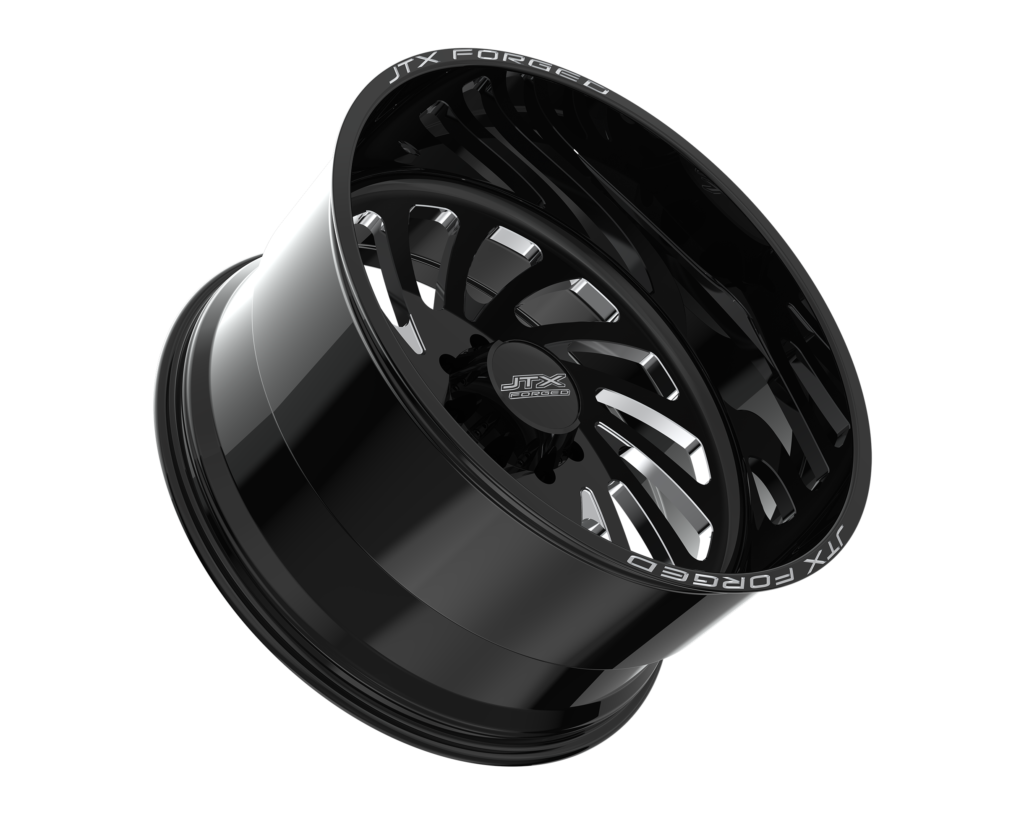 Black shiny alloy wheel on black background.