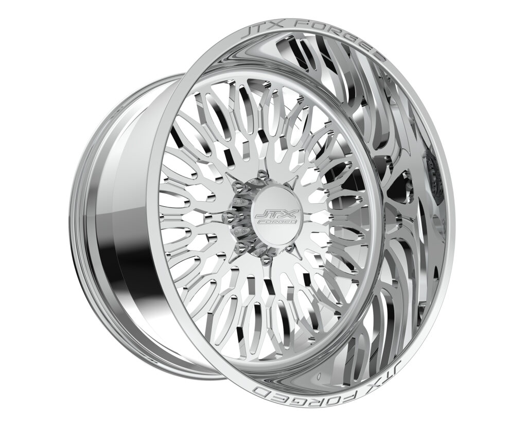 Chrome car wheel rim with intricate design.