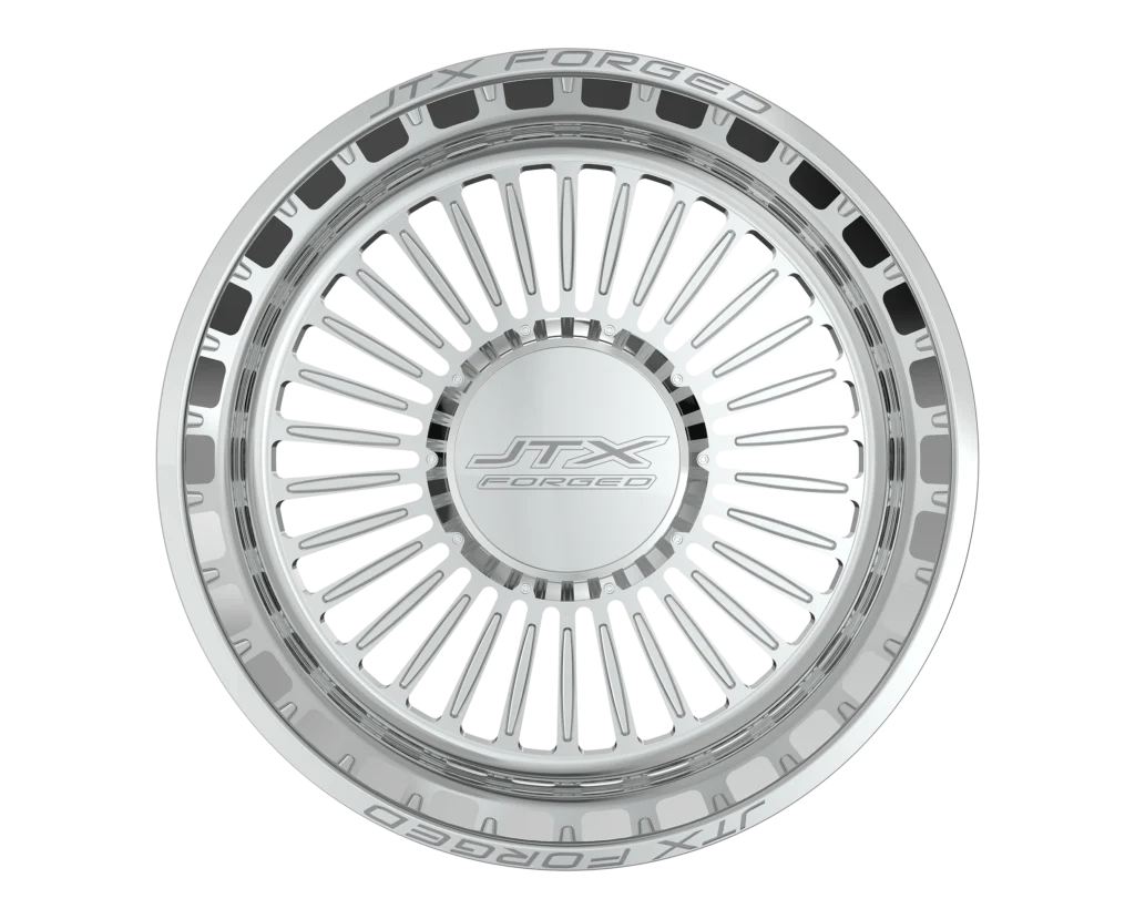 Silver wheel rim with intricate spoke design.